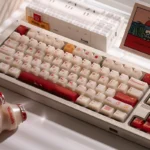 Playful Yakult artisan keycap set shaped like a mini bottle, featuring a whimsical design in warm red beige, perfect nostalgic desk art.