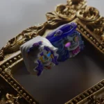 Close-up of a handcrafted translucent zombie bride & groom keycap, showcasing its intricate gothic resin art details and eerie glow from multiple angles.