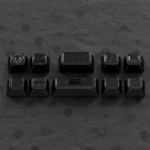 Close-up of a 80-bit Black Supplement Keycap Set, showcasing an iconic 8-bit gaming design. This high-quality retro keycap offers nostalgic feel.