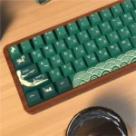 Close-up of the premium PBT Dye-Sub Animal Crossing keycap set, showcasing charming designs with deep greens and earthy tones from multiple angles.