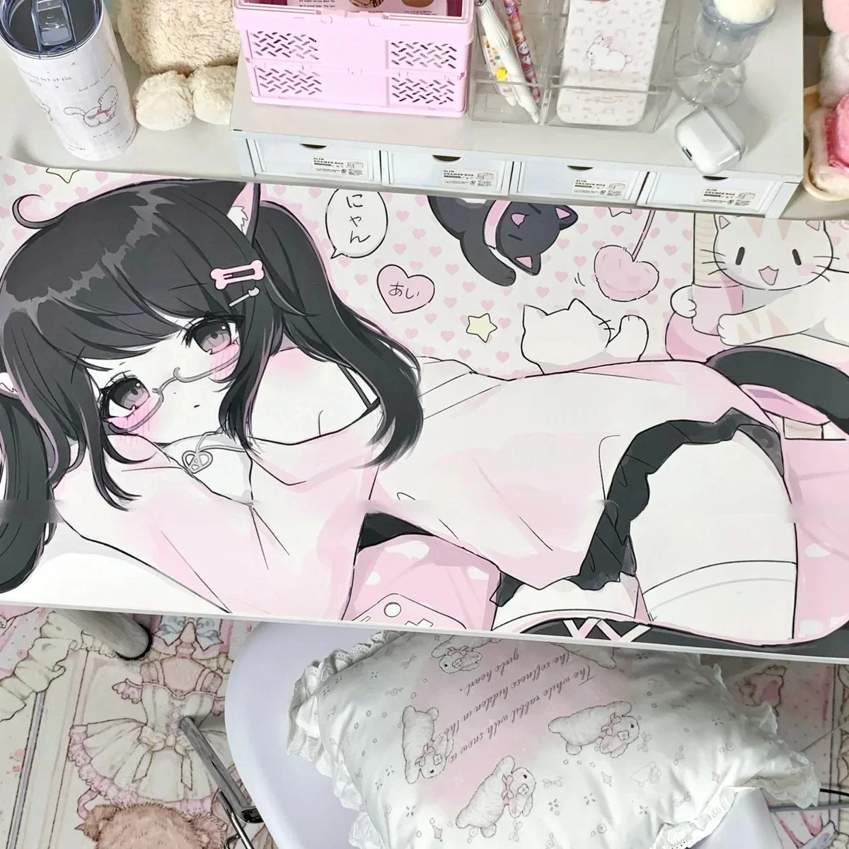 Close-up of the exclusive original anime cat girl art desk mat, emphasizing its charming design and soft pink and white palette from a playful angle.
