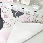 Multiple views of the exclusive anime cat girl art desk mat, showcasing its playful charm and soft pink and white design from various angles.