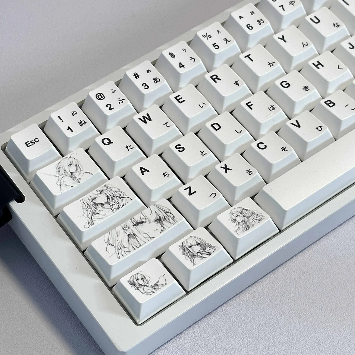 A collection of original minimalist anime PBT keycaps set for custom keyboards, showcasing their clean design, subtle graphics, and soft color palette.