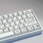 Anime PBT keycaps set, presented with artistic precision, highlighting its clean aesthetic, subtle graphic elements, and soft color design.