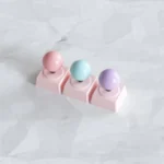 Arcade Joystick Keycaps from multiple angles. Features sleek metallic finishes and playful retro gaming icons, emphasizing quality.