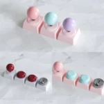 Experience retro gaming charm with this Arcade Joystick & Button Keycaps, showcasing miniature joystick designs and sleek metallic finishes.