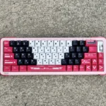 Iconic Arcee PBT keycap set. Vibrant pink, purple, white keycaps with durable PBT dye-sub legends, evoking futuristic Transformers nostalgia.