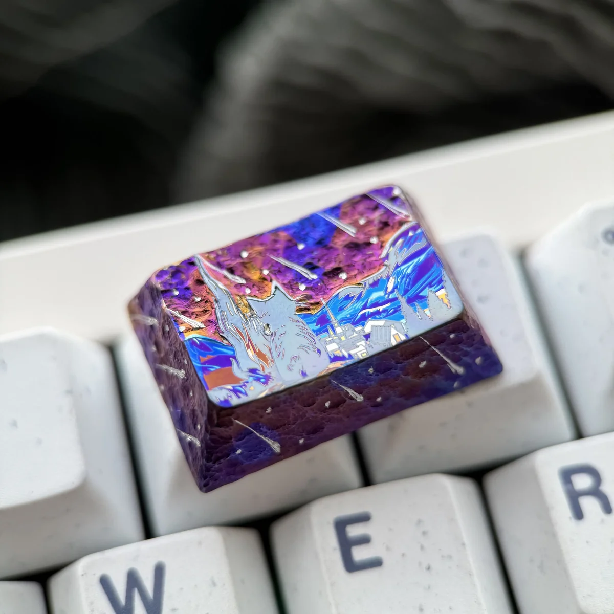 Ethereal purple starry sky artisan titanium keycap, handcrafted with shimmering stars and vibrant meteor trails against a deep cosmic expanse.