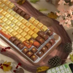 Close-up of Autumn Serenity PBT dye-sub keycaps set, showcasing crisp leaf designs and earthy tones for a tranquil keyboard aesthetic.