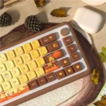 Autumn Glow MDA PBT Dye-Sub keycap set showcased from various angles, featuring warm, earthy tones and artistic seasonal motifs on durable PBT construction.