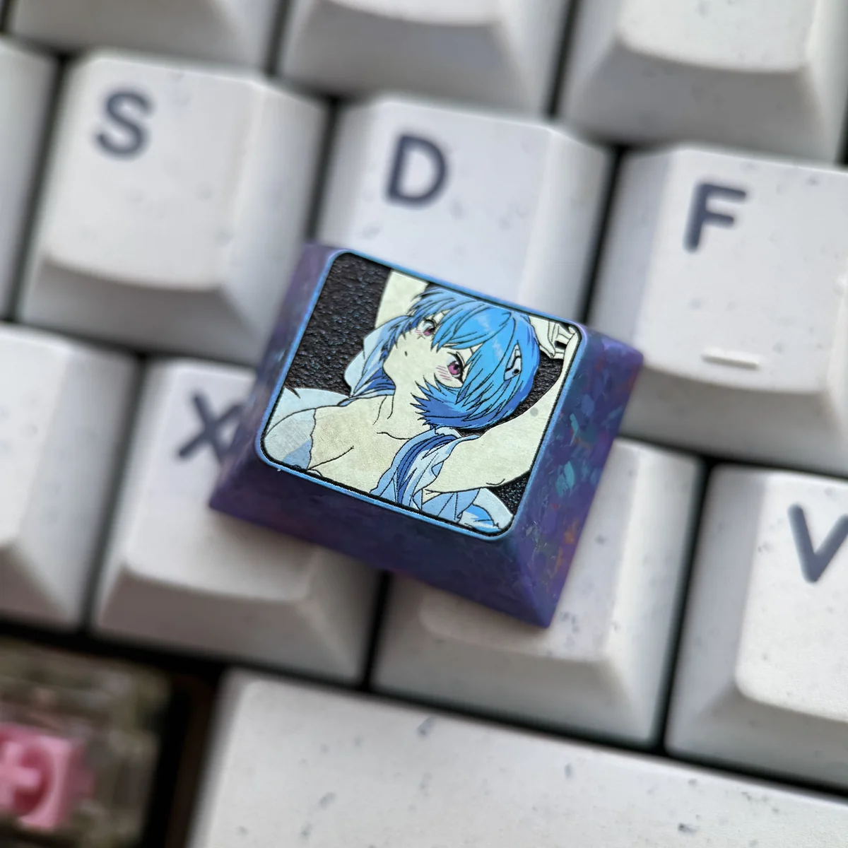 Close-up of the premium Ayanami Rei Titanium Keycap for Evangelion fans, showcasing its sleek metallic finish and intricate anime design.