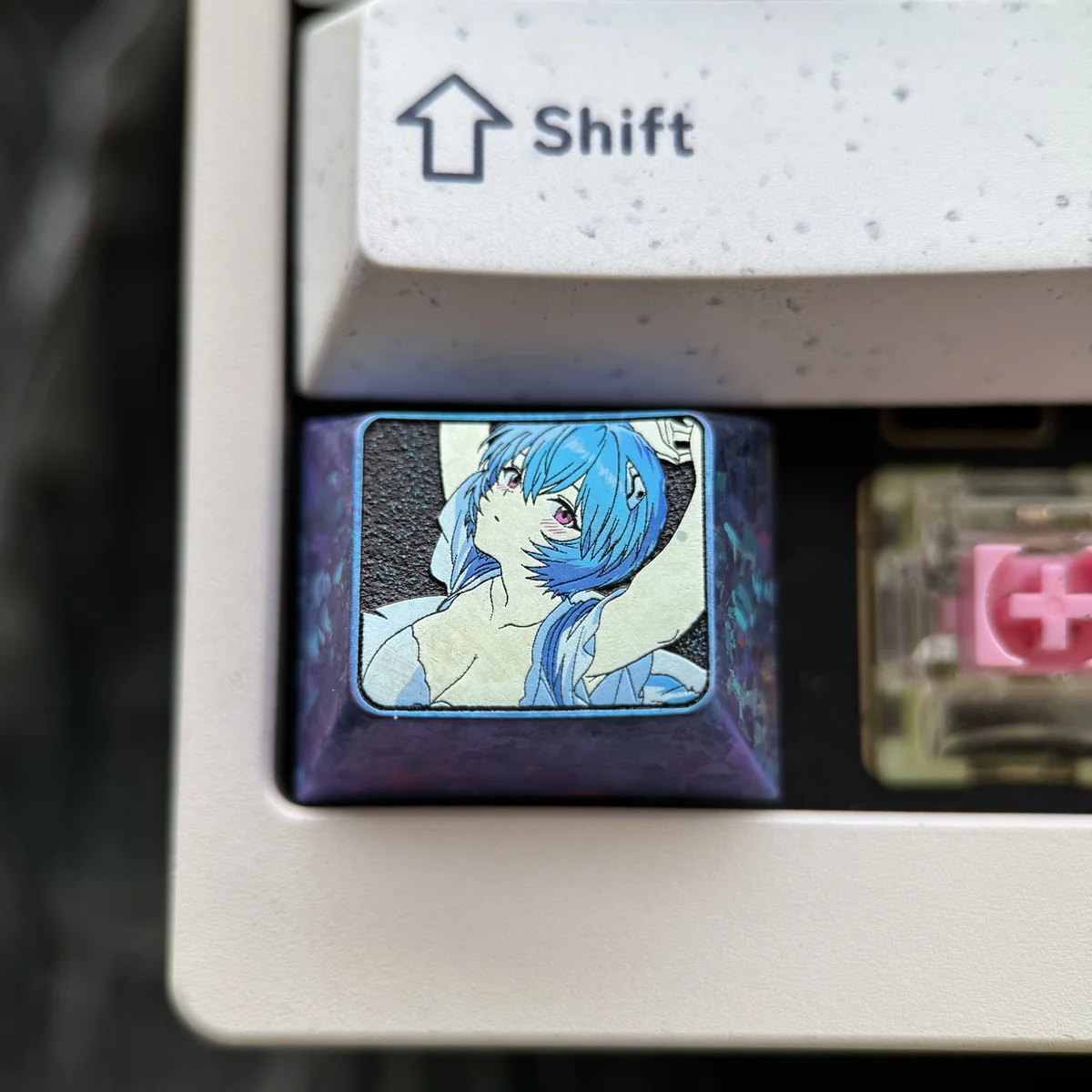 Iconic Ayanami Rei Titanium Alloy Keycap from Evangelion, showcasing sleek metallic design and premium craftsmanship.