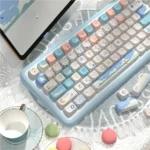 Vibrant Beach Summer PBT SCA profile keycaps set displayed from multiple angles, showcasing their durable design, vivid blues, and warm sand tones.