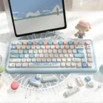 Vibrant Beach Summer Keycaps Set, crafted from durable PBT with an SCA profile, showcasing tranquil ocean blues and warm sands for an artistic keyboard.