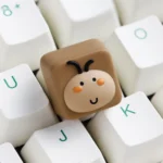 Whimsical big-head cockroach artisan keycap, multiple angles. Highlights its unique, expressive design, adding playful joy and stress relief to your keycap.
