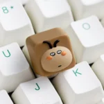 Whimsical big-head cockroach artisan keycap with a dreamy, dazed expression, a unique, expressive, stress-relieving collectible.
