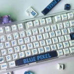 Playful blue pixel PBT dye-sub keycaps set for mechanical keyboards, showcasing durable, bold retro-pixel design from various angles, offering broad compability.