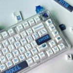 Playful blue pixel PBT dye-sub keycaps set for mechanical keyboards, revealing their durable, bold retro-digital design from various angles.