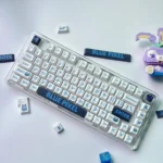 Playful blue PBT dye-sub keycaps set showcasing a bold retro-pixel design with large, clear legends, perfect for upgrading any mechanical keyboard.