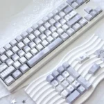 Broken Window Butterfly Cherry Keycap Set, viewed from artistic angles, highlighting delicate butterfly designs and vibrant side-lit legends breaking free.