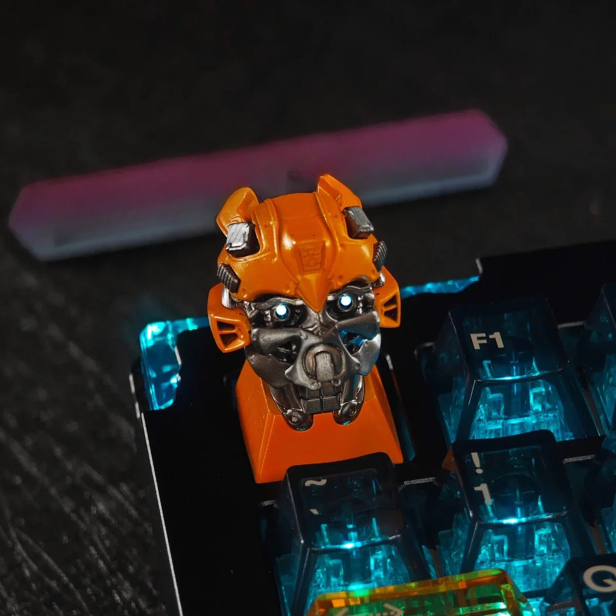 Iconic Bumblebee Transformers artisan keycap, vibrant yellow and black, showcasing backlit translucent design for mechanical keyboards.