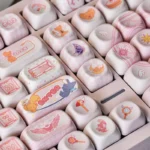 Detailed view of Cardcaptor Sakura PBT MOA keycaps set, showcasing pastel colors, sparkling stars, and iconic Sakura designs for a magical anime aesthetic design.