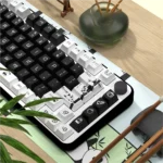 Detailed view of charming panda PBT dye-sub keycaps set, revealing their clean, minimalist black and white design and playful aesthetic from various angles.