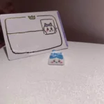 Close-up of a whimsical handmade Chiikawa artisan keycap, showcasing its unique resin charm and meticulously sculpted character from various angles.