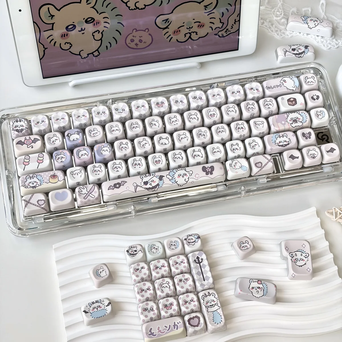 An angled view of vibrant Chiikawa Momonga backlit keycaps set, featuring adorable side-printed characters and translucent pastel designs.