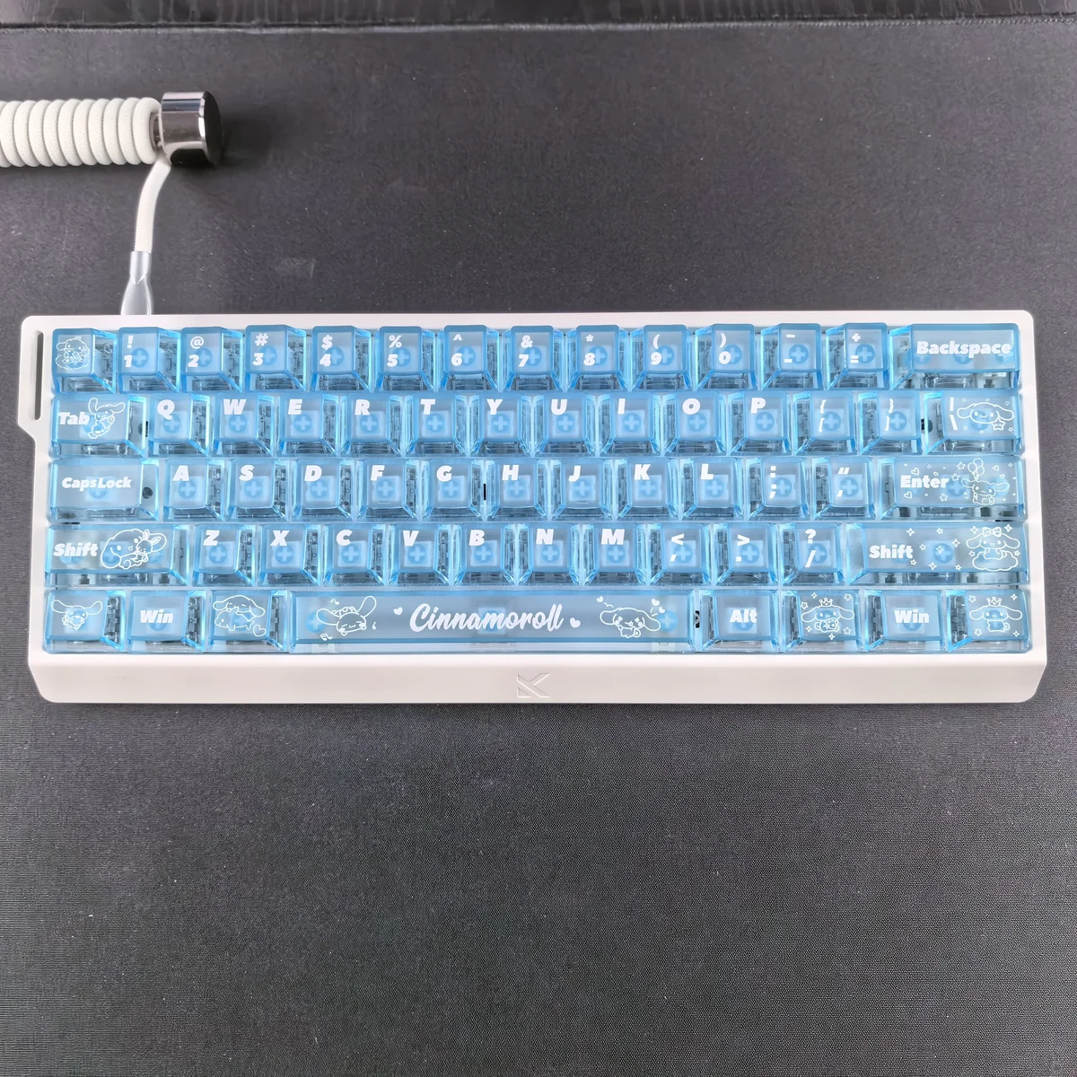 Adorable Cinnamoroll translucent PC keycaps set arranged playfully, highlighting their dreamy blue mist glow and transparent design, perfect for captivating setup.
