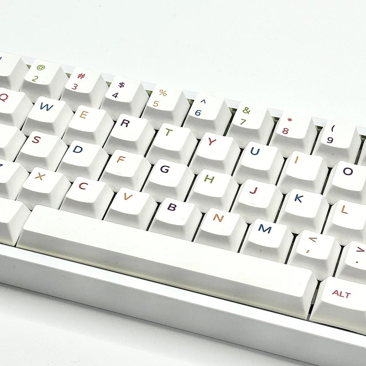 A vibrant colorful PBT keycaps set, dynamically angled to reveal its playful spectrum of hues, perfect for personalizing custom keyboards with modern design.