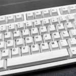 Durable Monochromatic Cosmic PBT Keycaps Set from an artistic angle. Highlighting elegant monochromatic cosmic design, celestial patterns, and deep space wonder.