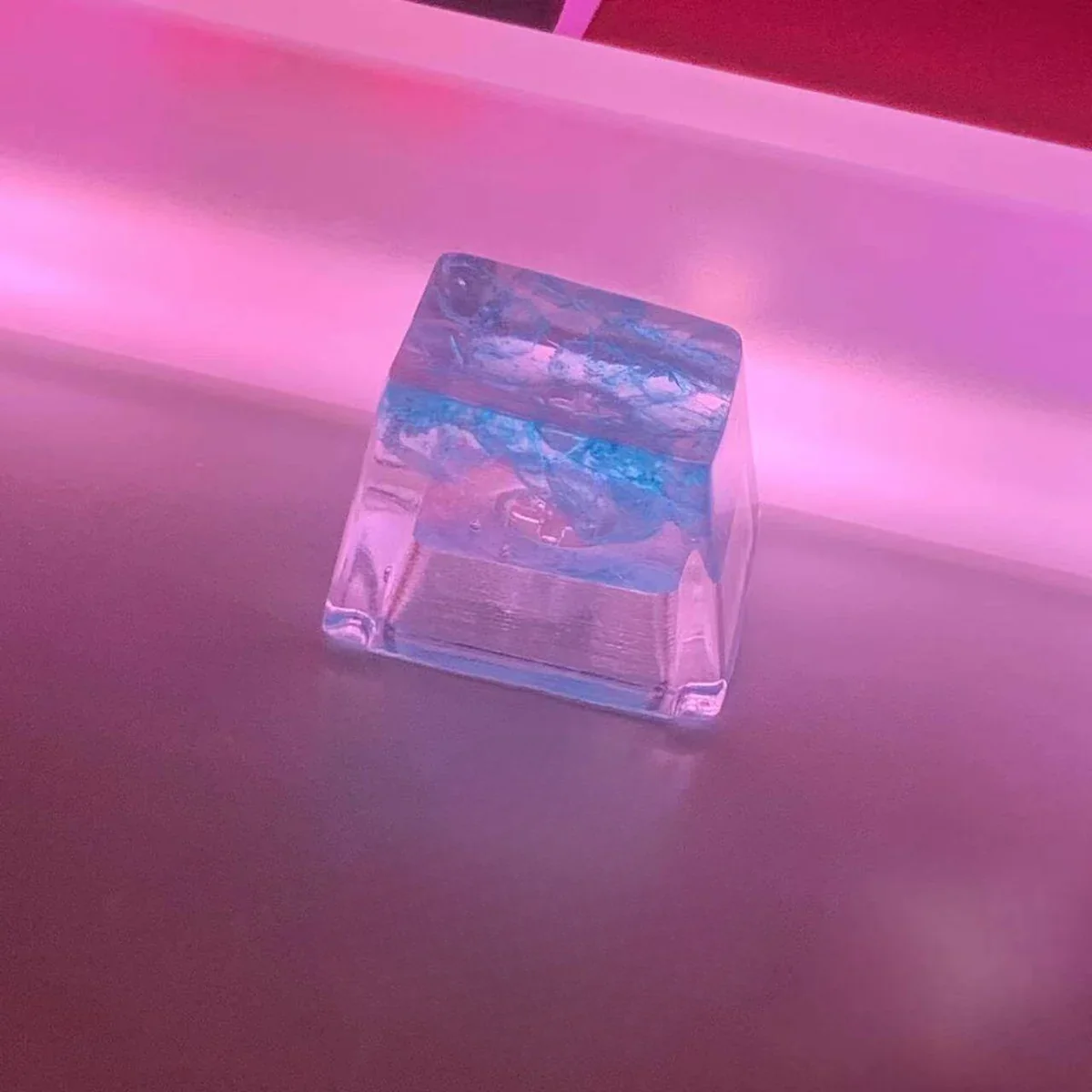 Vibrant, handmade Crushed Ice Keycap, angled to reveal its translucent texture and sparkling crystal filling. This playful summer treat offers a refreshing style.