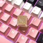 A vibrant, translucent handmade Crushed Ice Keycap, showcasing its unique sparkling crystal filling and refreshing texture from multiple playful angle.