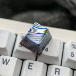 Unique handcrafted Damascus titanium ESC keycap gallery, displaying intricate patterns and iridescent hues from various premium angles.