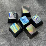 Close-up of a unique handcrafted Damascus Titanium ESC keycap, showcasing its intricate, iridescent patterns and premium modern aesthetic.