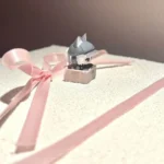 Handcrafted Delta Force Luna artisan keycap, showcasing its intricate sculpted details and dark, playful cat motif from a unique angle.