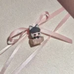 Close-up of the handcrafted Delta Force Luna artisan keycap, revealing its intricate sculpting and dark, playful cat motif from a distinctive design.