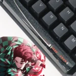 Artisan Demon Slayer RGB spacebar keycap featuring in striking black and red resin with a luminous, starry finish.