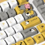 Whimsical dog theme PBT MDA keycap set, featuring adorable dog illustrations and paw prints on durable, warm-colored keycaps from a playful angle.