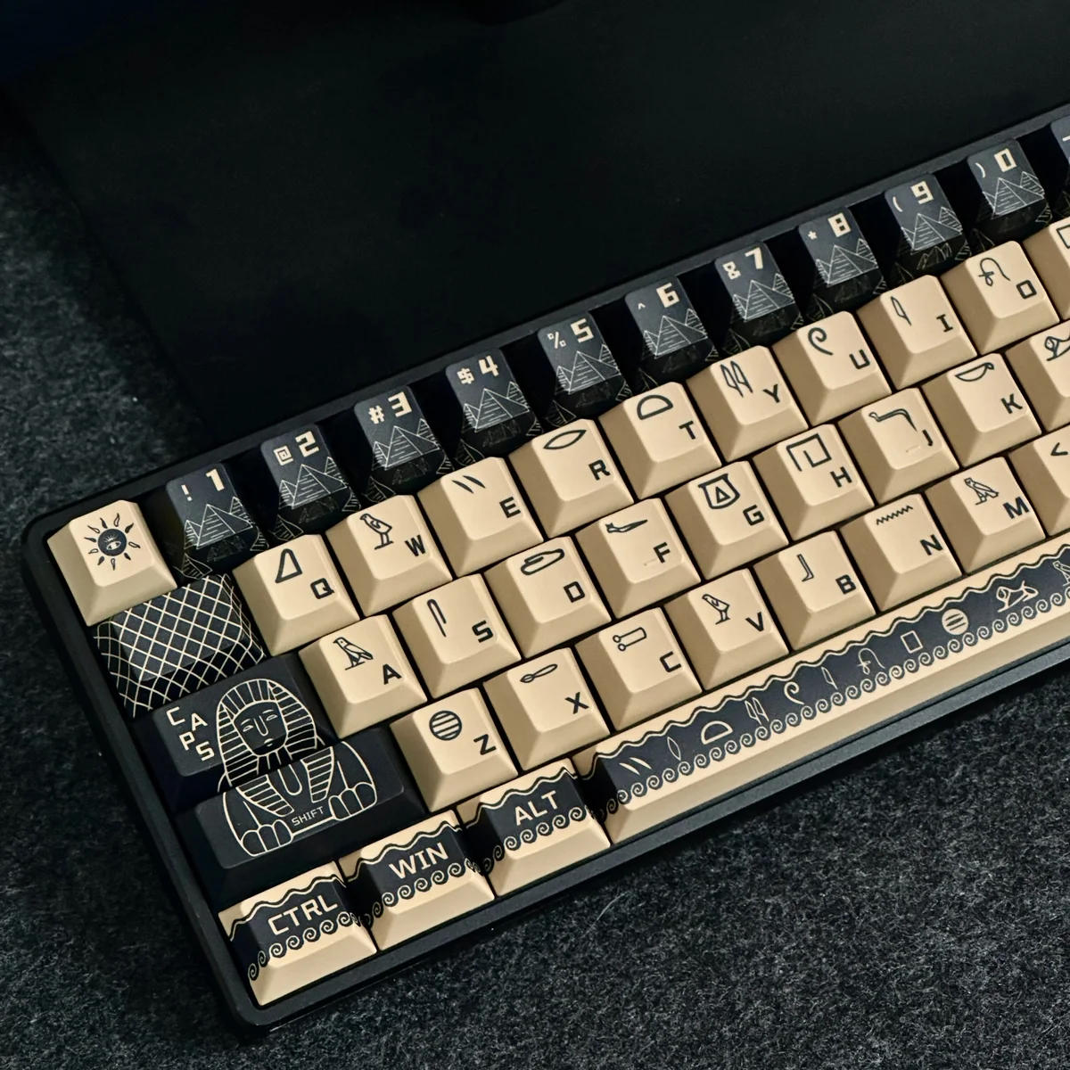 Durable PBT dye-sub Egyptian Pharaoh keycaps set, displayed from multiple angles, show intricate golden hieroglyphs and desert hues, evoking regal ancient.