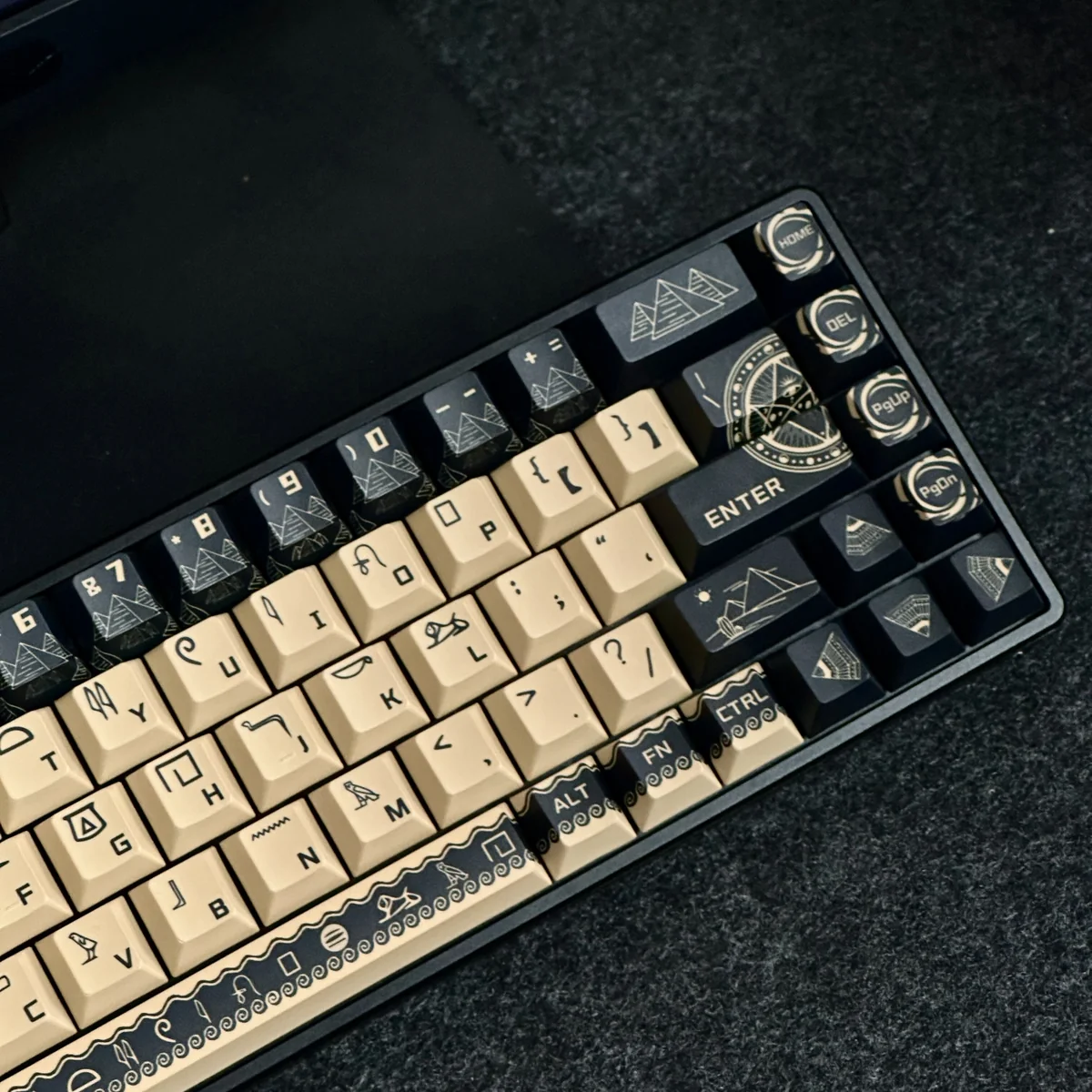 Artistic view of durable PBT dye-sub Egyptian Pharaoh keycaps set, showcasing intricate golden hieroglyphs and desert hues from a distinct angle for mechanical keyboard.