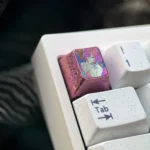 Elysia Titanium Keycap for Honkai Impact 3rd ESC, showcasing ethereal character art on polished titanium from multiple angles, highlighting its premium design.