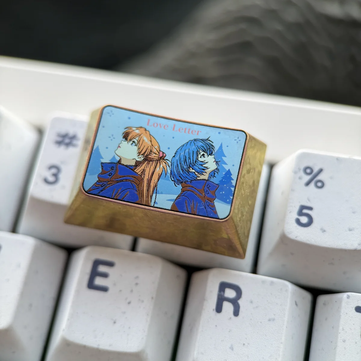 Premium titanium Evangelion keycaps showcasing Asuka and Rei, presented from various angles to reveal the exquisite craftsmanship and durable, high-tech design.