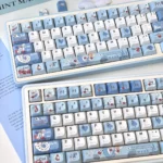 A close-up view of the unique Fallen Alice in Wonderland dark fantasy keycaps set, showcasing intricate details and melancholic artistry from a unique design.