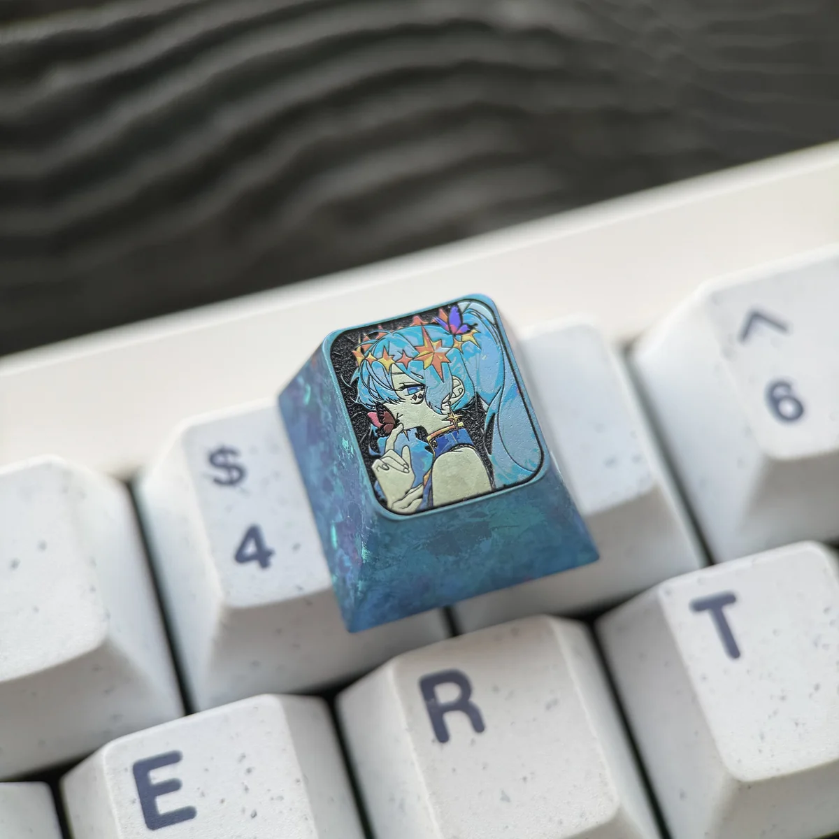 Exclusive Hatsune Miku Titanium Artisan ESC Keycap, shown from a captivating angle, highlighting its vibrant festive art and polished titanium craftsmanship.