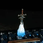 Detailed artisan Frostmourne keycap with its iconic removable sword, featuring epic dark fantasy runes and icy blue accents, shown from various angles.