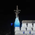 Artisan Frostmourne keycap from a side angle, highlighting the interactive removable sword's detailed hilt and glowing blue design.