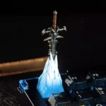 Artisan Frostmourne Keycap featuring a detailed, removable sword. This interactive piece embodies dark fantasy with icy blue accents and ancient rune design.