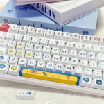 Playful retro pixel PBT dye-sublimation gaming keycaps set, shown from multiple angles, highlighting durable PBT and vibrant classic arcade art for broadcase.